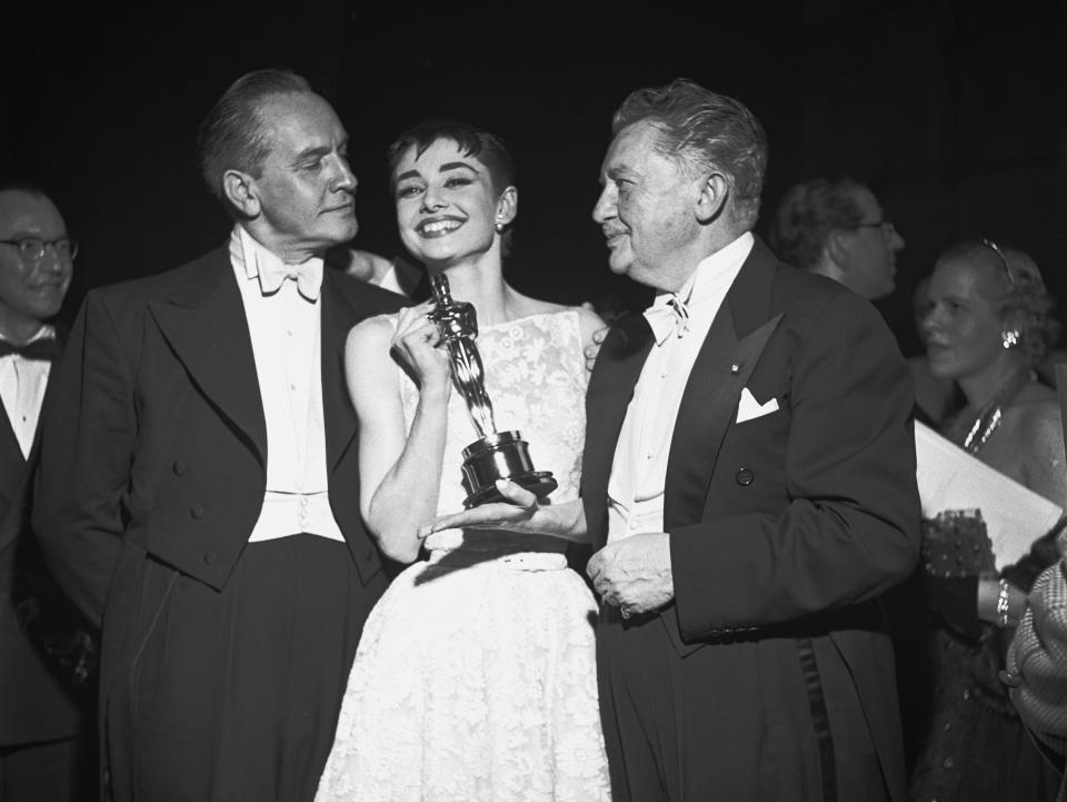 Audrey Hepburn smiles with her best actress award for her performance in 
