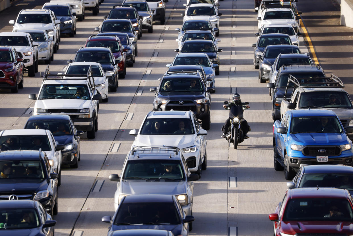 SAN DIEGO, CALIFORNIA - FEBRUARY 9: A motorcyclist spits lanes as commuters sit in traffic on southbound Interstate 5 during the afternoon commute on February 9, 2024 in San Diego, California.  (Photo by Kevin Carter/Getty Images)