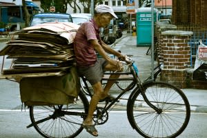 Old man carting cardboard boxes