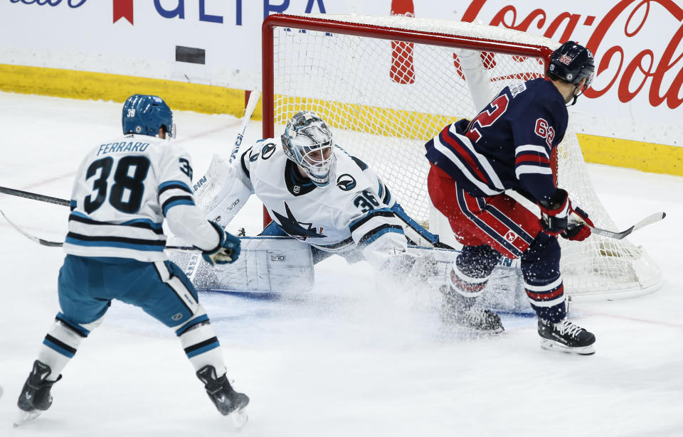 San Jose Sharks goaltender Kaapo Kahkonen (36) saves the breakaway attempt by Winnipeg Jets' Nino Niederreiter (62) during the second period of an NHL hockey game Wednesday, Feb. 14, 2024, in Winnipeg, Manitoba. (John Woods/The Canadian Press via AP)