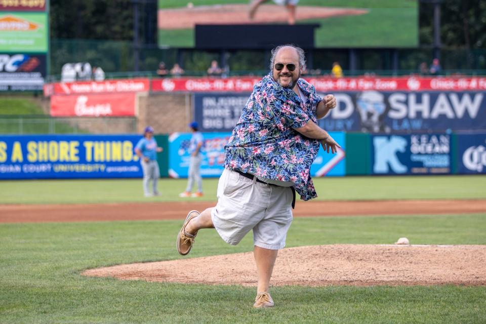 Jersey Shore BlueClaws play-by-play announcer Greg Giombarrese throws out the first pitch at a game to commemorate calling his 1,000th home game for the team.