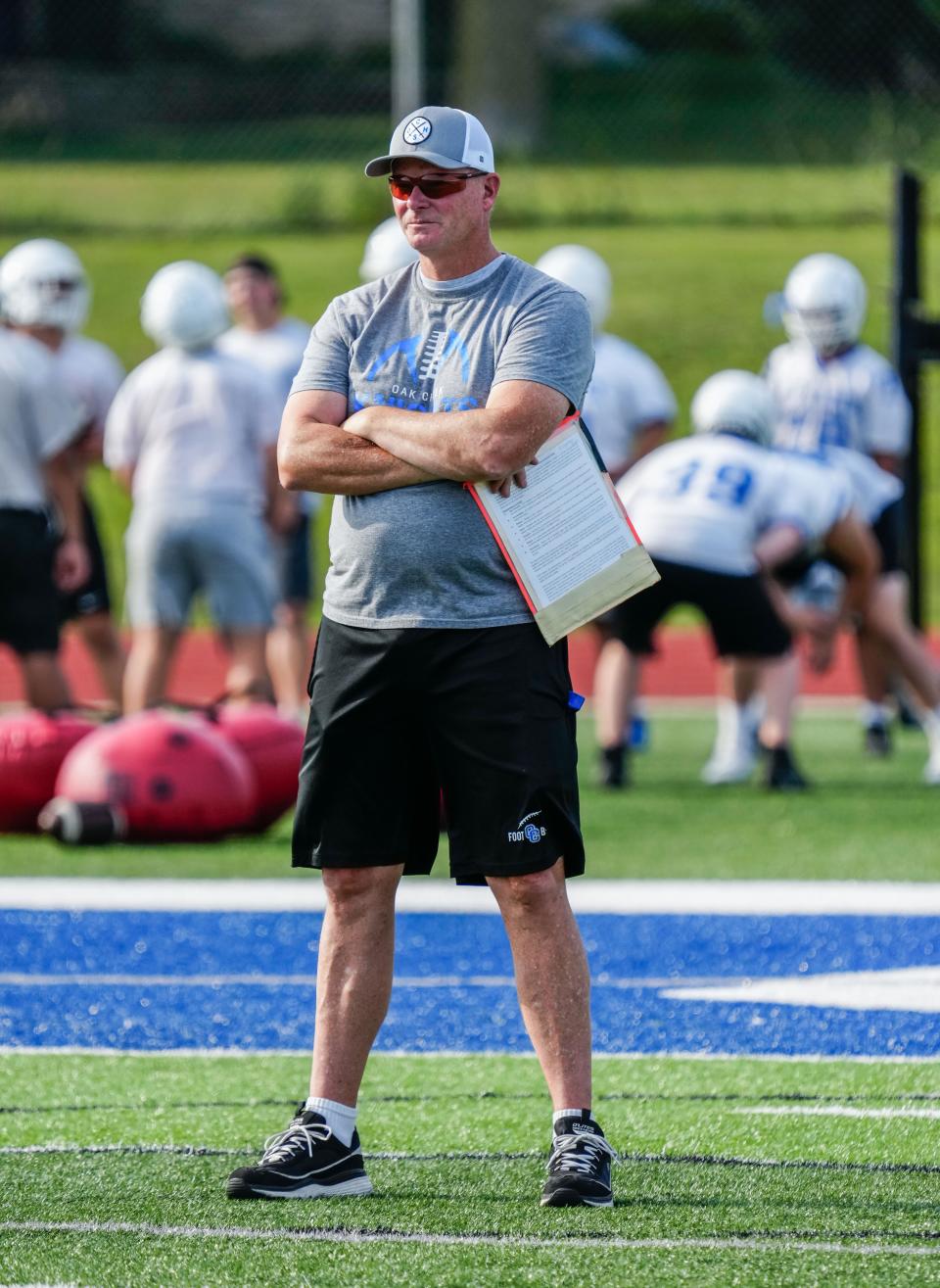 Oak Creek High School varsity football coach Joel Paar watches a drill during practice on Wednesday, August 2, 2023.