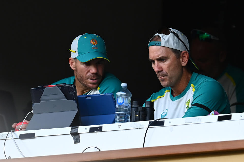 David Warner (pictured left) has defended Justin Langer (pictured right) speak during a match.