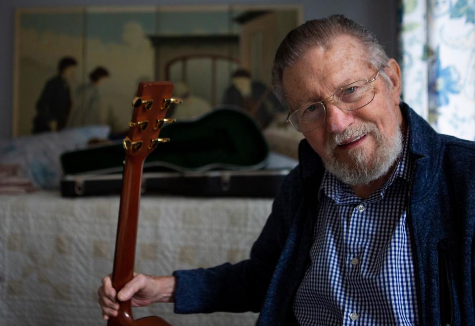 Bob Harvey, of Hideaway Hills, sits inside his home with his guitar in Hideaway Hills in Sugar Grove, Ohio on March 23, 2022. Harvey was the original bass guitar player for the band Jefferson Airplane.