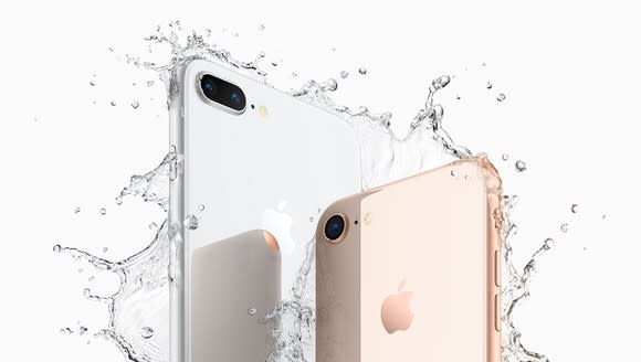 Apple's iPhone 8 Plus and iPhone 8 shown being splashed with water.