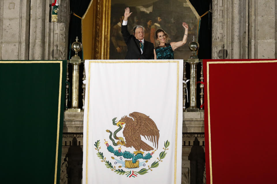 President Andres Manuel Lopez Obrador and first lady Beatriz Gutierrez Muller wave after Lopez Obrador gave the annual independence shout from the balcony of the National Palace to kick of Independence Day celebrations at the Zocalo in Mexico City, Sunday, Sept. 15, 2019. Every year the Mexican president marks the "Grito de Dolores," commemorating the 1810 call to arms by priest Miguel Hidalgo that began the struggle for independence from Spain, achieved in 1821.(AP Photo/Rebecca Blackwell)