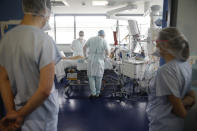 Medical workers tend a patient suffering of COVID-19 in the Nouvel Hopital Civil of Strasbourg, eastern France, Thursday, Oct.22, 2020. France has seen over 34,000 confirmed deaths in the pandemic. (AP Photo/Jean-Francois Badias)