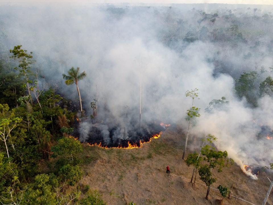 TOPSHOT - Firefighters try to put out an illegal fire in a forest area at the Cacau Pirera district in Iranduba, Amazonas state, Brazil on September 25, 2023. The Government of Amazonas declared a State of Environmental Emergency on September 12 due to the high number of fires and a strong drought in the rivers, affecting navigation and food distribution to the interior of the state. (Photo by Michael DANTAS / AFP) (Photo by MICHAEL DANTAS/AFP via Getty Images)