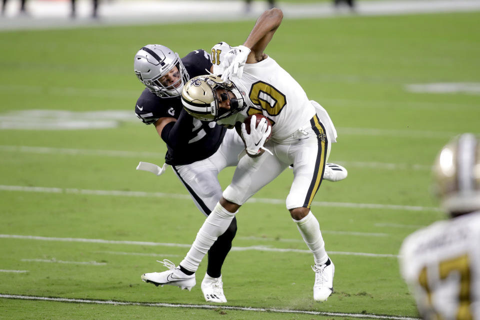 New Orleans Saints wide receiver Tre'Quan Smith (10) breaks a tackle from Las Vegas Raiders free safety Erik Harris during the first half of an NFL football game, Monday, Sept. 21, 2020, in Las Vegas. (AP Photo/Isaac Brekken)