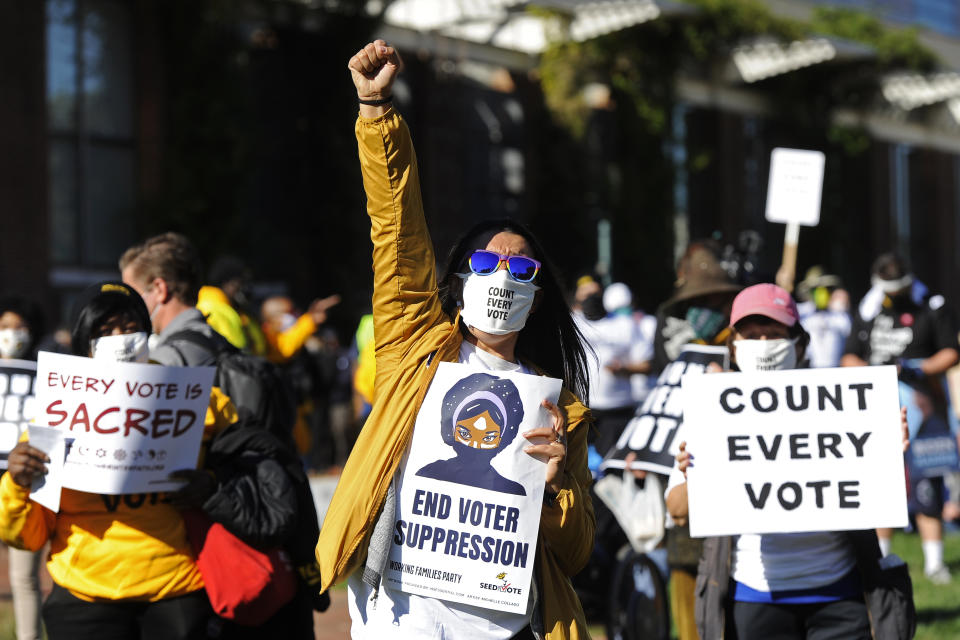 People listen and react to speakers during a count every vote protest at Independence Mall, Tuesday, Nov. 4, 2020, in Philadelphia. (AP Photo/Michael Perez)