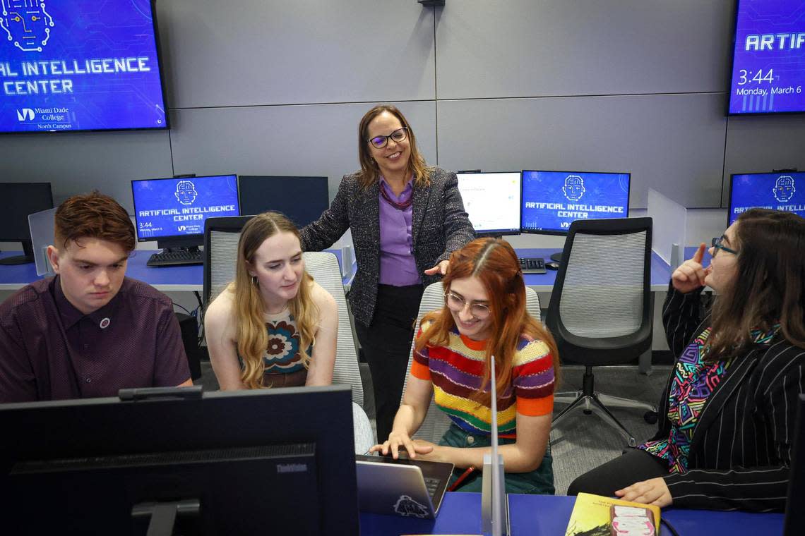 Carmen Butcher, an English and communications professor, rear, works with students, from left to right, Lucas Fernandez, Jacklyn Calzadilla, Lea Rabaron, and Grace Penza, to solve a problem during an artificial intelligence class at Miami Dade College’s North Campus on March 6, 2023. They are trying to use AI to look for literary devices in the Harry Potter novels.