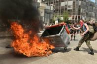 Protesters set fire to bins during demonstrations in Rennes on May 26, 2016