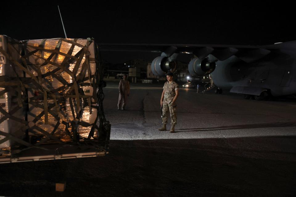 Lebanese military member stands while palettes of aid for Lebanon delivered by United Arab Emirates is being moved (REUTERS)