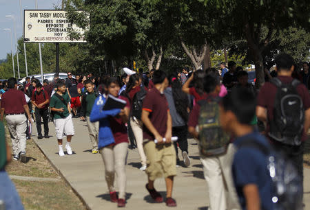 Students leave Tasby Middle School, where a fellow classmate who was in contact with a man diagnosed with the Ebola virus had been removed from school in Dallas, Texas October 1, 2014. REUTERS/Mike Stone