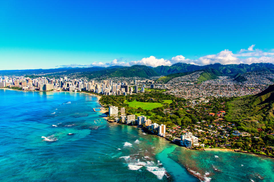 The entire coastline of Honolulu, Hawaii including the base of Diamond Head crater and state park, past the hotel lined Waikiki Beach towards downtown in the distance including the suburban neighbourhoods dotting the hills surrounding the city centre. (Getty Images)