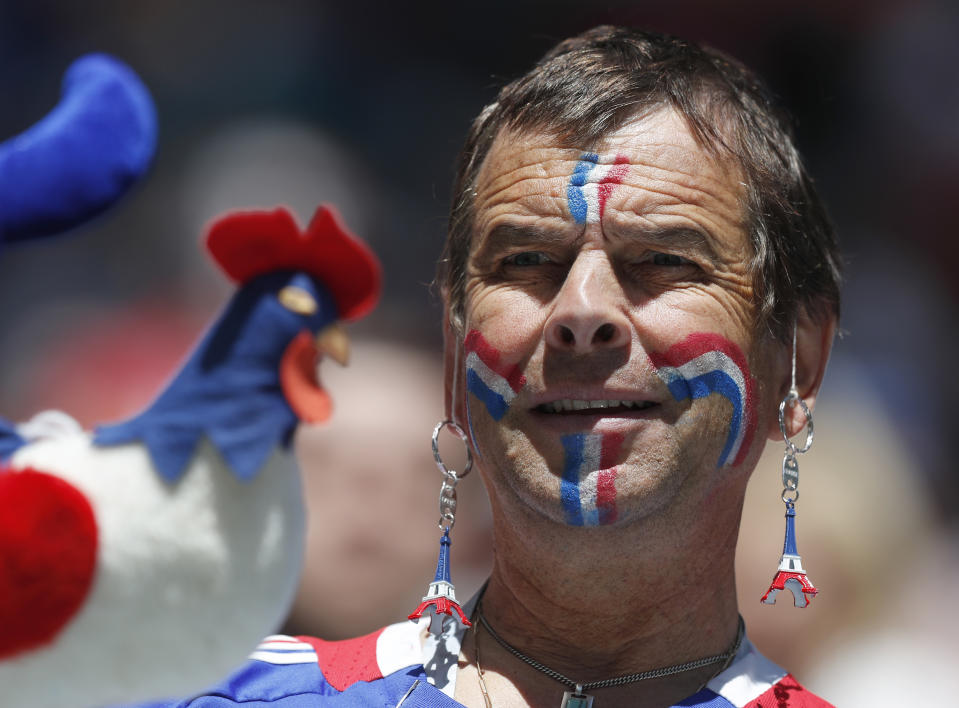 <p>A colourful French supporter wearing Eiffel Tower earrings as he waits for the start of the group C match (AP) </p>
