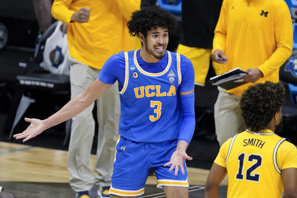 UCLA guard Johnny Juzang (3) questions a call during the first half of an Elite 8 game against Michigan in the NCAA men's college basketball tournament at Lucas Oil Stadium, Tuesday, March 30, 2021, in Indianapolis. (AP Photo/Darron Cummings)