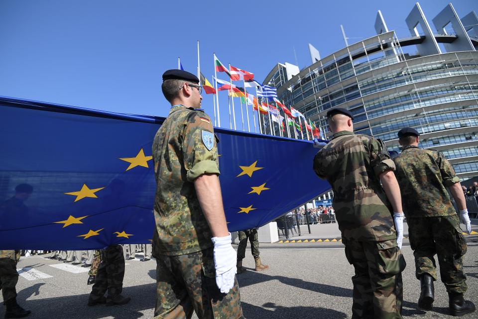 Soldiers of Eurocorps carry an European Union flag during the flag-raising ceremony on the eve of the inaugural session of new European Parliament on July 1, 2019 in front of Louise Weiss building (R), headquarters of the European Parliament in Strasbourg, eastern France. (Photo by FREDERICK FLORIN / AFP)        (Photo credit should read FREDERICK FLORIN/AFP/Getty Images)