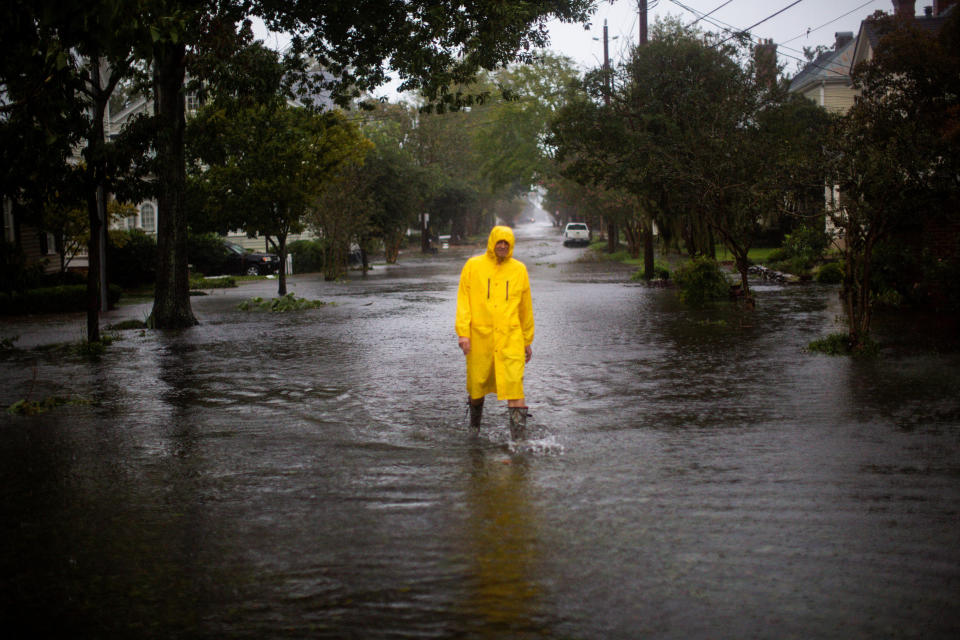 A man walks through flooded streets in New Bern.