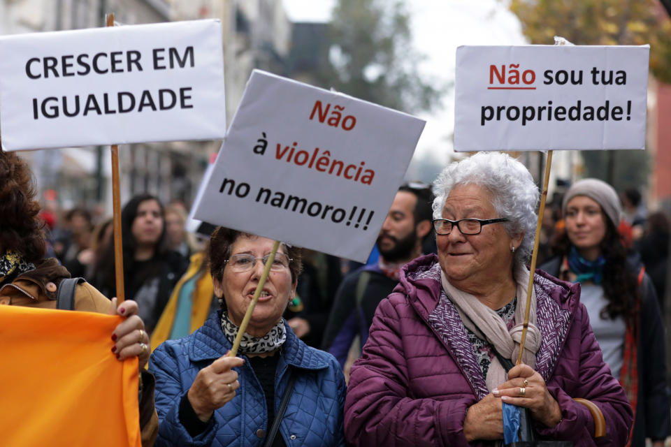 <p>Two elderly women hold banners with the words “I’m not your property” (right) and “No to the violence in relationship” (center) as another woman holds another with the words “growing equal” during a demonstration marking the International Day for the Elimination of Violence Against Women in Lisbon, Portugal, Nov. 25, 2017. (Photo: Antonio Cotrim/EPA-EFE/REX/Shutterstock) </p>