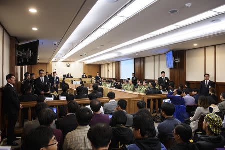 Sewol ferry crew members (centre R) attend the start of verdict proceedings at a court room in Gwangju November 11, 2014. REUTERS/Ed Jones/Pool