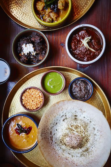 <p>If hoppers, dosas and kothu inspired by Sri Lankan and south Indian dining tickles your taste buds, then a night a hoppers in a must to romance your SO.</p><p>If you’re on a budget, we suggest tucking into several plates like devilled squid, prawn vadai, hot butter chilli paneer, Jaffna beef rib fry and duck roti. For those with a bit more cash to spare, you must try the crab kari, egg hopper, coconut chutney, lamb shank buriani and goat kothu roti. </p><p>The décor at Hoppers is simple yet sophisticated, furnished with yellow walls covered in vintage photos in its Soho branch and white walls, spherical lamps and trees in its St Christopher’s base. </p><p>It’s so popular with Londeners that it has just opened its third branch in King's Cross. </p><p><strong>Click <a href="https://linktr.ee/hopperslondon" rel="nofollow noopener" target="_blank" data-ylk="slk:here;elm:context_link;itc:0;sec:content-canvas" class="link ">here</a> to find out more.</strong></p><p><strong>Locations: Soho, St Christopher’s and King’s Cross.</strong></p>