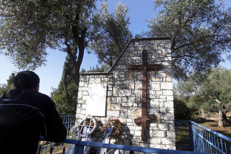 A man looks at the tomb of fallen Greek World War Two soldiers in Himara, Albania January 26, 2018. Picture taken January 26, 2018. REUTERS/Florion Goga