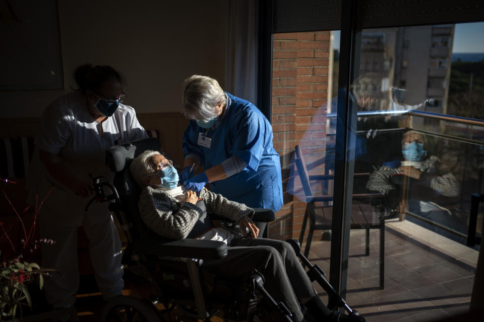 FILE - In this Jan. 12, 2021, file photo, a nurse administers the Pfizer-BioNTech COVID-19 vaccine to a resident at the Icaria nursing home in Barcelona, Spain. The global death toll from COVID-19 has topped 2 million. (AP Photo/Emilio Morenatti, File)