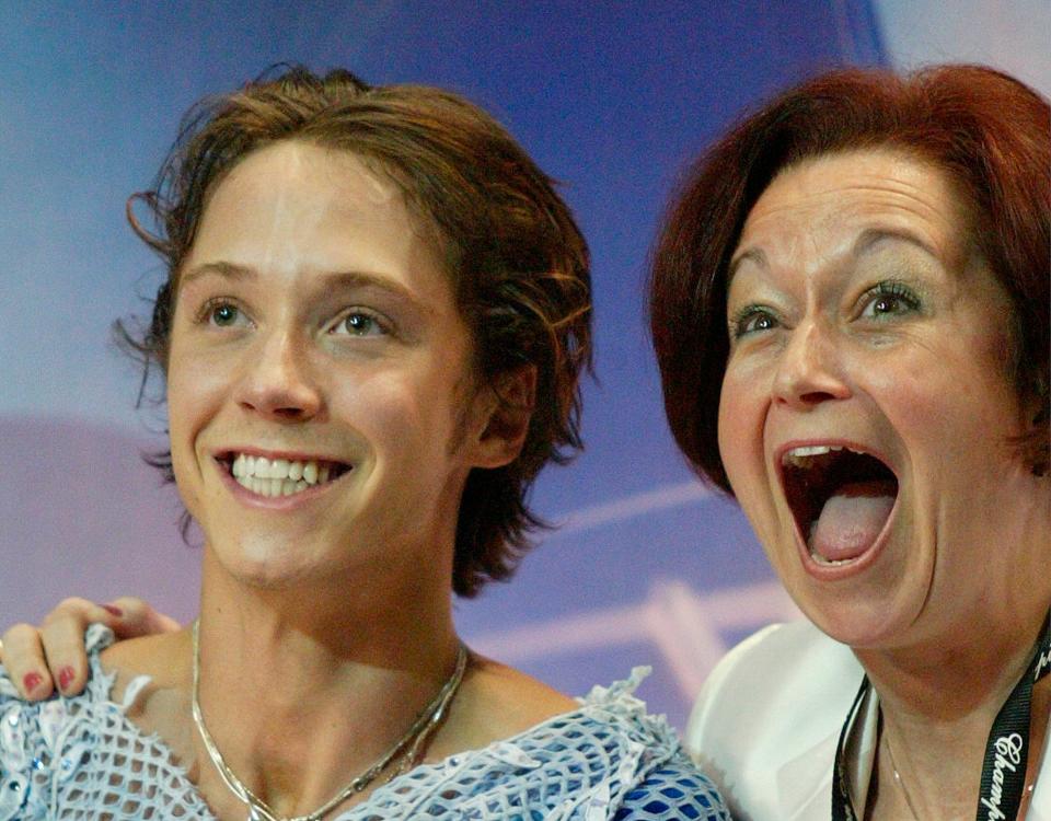 Johnny Weir and coach Priscilla Hill celebrate his first place victory at the U.S. Figure Skating Championship Men's Free Skate Saturday, Jan. 15, 2005, at the Rose Garden, in Portland, Ore.