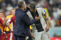 Germany's head coach Hansi Flick, left, talks with Germany's Lukas Klostermann at the end of the World Cup group E soccer match between Spain and Germany, at the Al Bayt Stadium in Al Khor , Qatar, Sunday, Nov. 27, 2022. (AP Photo/Luca Bruno)