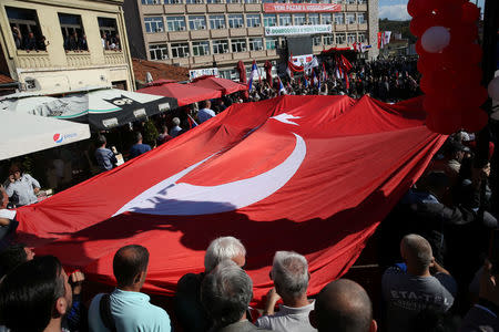People carry Turkish flag as Turkish President Tayyip Erdogan and his Serbian counterpart Aleksandar Vucic visit Novi Pazar, Serbia, October 11, 2017. REUTERS/Marko Djurica