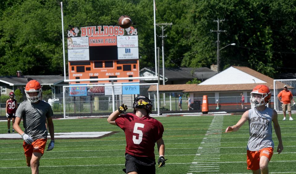 Newark's Trey Robinson (center) awaits a pass while playing Heath in a 7-on-7 scrimmage last month at Swank Field.