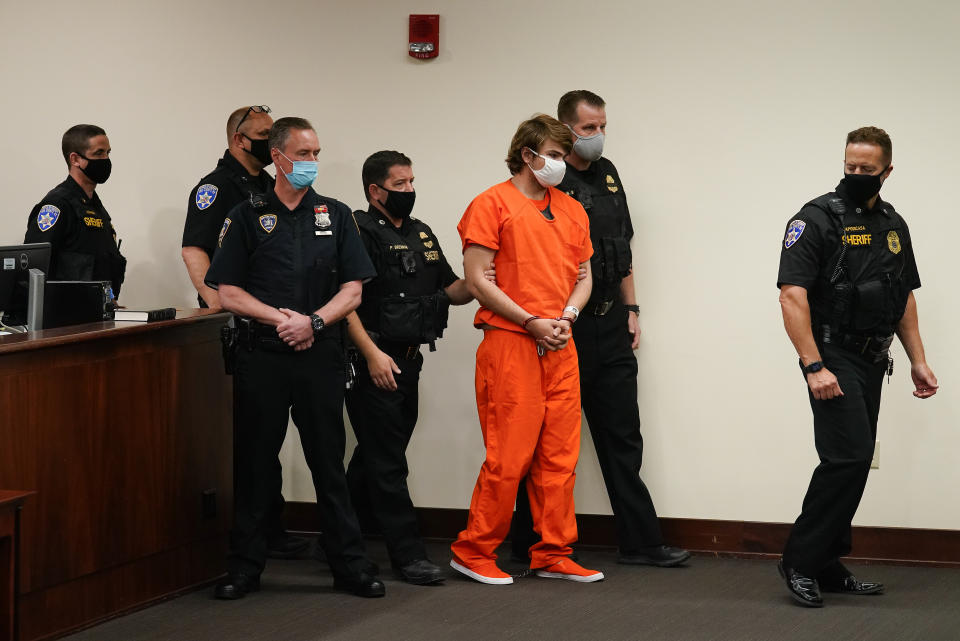 FILE - Payton Gendron is led into the courtroom for a hearing at Erie County Court, in Buffalo, N.Y., Thursday, May 19, 2022. Gendron faces charges in the May 14 fatal shooting at a supermarket. Relatives of those killed and wounded in a racist mass shooting at a Buffalo supermarket in May have been told the gunman will plead guilty to state charges next week, a lawyer for the families said Thursday. (AP Photo/Matt Rourke, File)