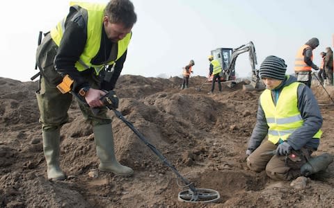 Amateur archaeologist Rene Schoen, left, and 13-year-old student Luca Malaschnichenko at the dig where the coins were found - Credit: STEFAN SAUER/ DPA