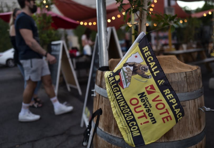 A replace and recall California Gov. Gavin Newsom is seen as guests arrive for an election party at the Pineapple Hill Saloon & Grill in Los Angeles on Tuesday, Sept. 14, 2021. A small group of pro-recall voters gathered at the bar and eatery to watch the results come in. (AP Photo/Richard Vogel)