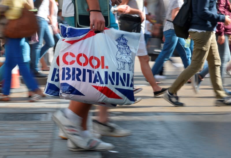 Shoppers cross Oxford Street in central London August 15, 2013. REUTERS/Toby Melville