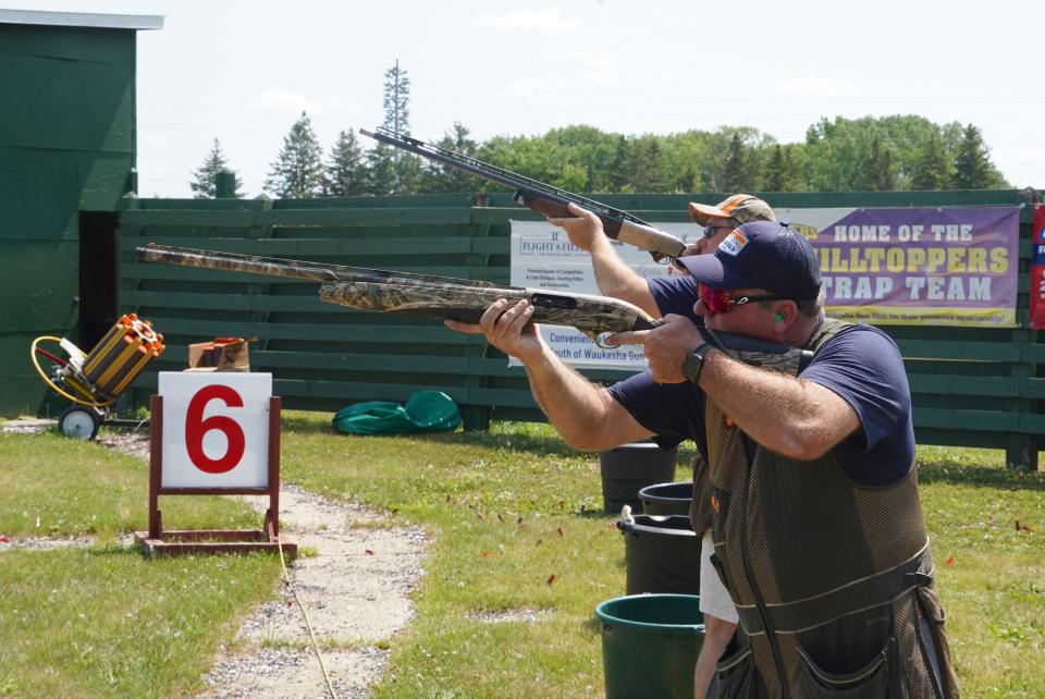 Pete Schraufnagel of Nashotah (foreground) and his brother Steve Schraufnagel of Germantown compete in a "beat the Schraufnagels" side event at Christopher's Shoot Against Childhood Cancer at Waukesha Gun Club. The overall event raised $278,773 for the MACC Fund.