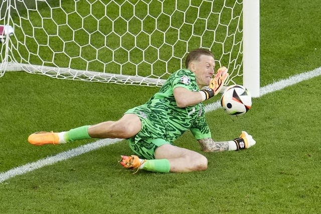 Jordan Pickford dives to save a penalty during England's win over Switzerland