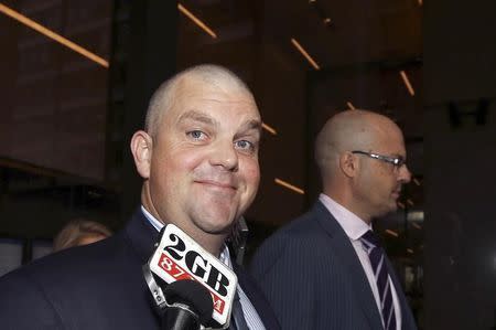 Former Australian billionaire Nathan Tinkler (L) talks to a journalist as he arrives to the New South Wales Supreme Court in central Sydney March 14, 2013. REUTERS/Steve Christo