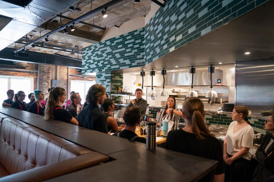 The wait staff at Vigilante Kitchen gets some instructions before the restaurant opens on June 30, 2023. This has been the dream of executive chef and owner Aaron Cozadd, who has conceptualized an immersive venue that encompasses Zen vibes, punk rock and graphic novels.