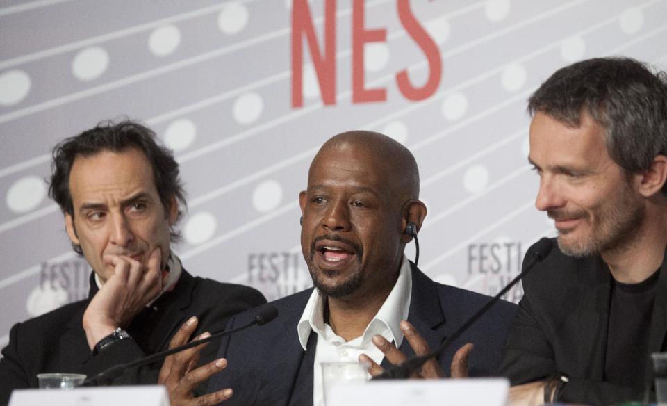 Actor Forest Whitaker, center, speaks during a press conference for the film Zulu at the 66th international film festival, in Cannes, southern France, Sunday, May 26, 2013. At left is composer Alexandre Desplat and director Jerome Salle. (AP Photo/Virginia Mayo)