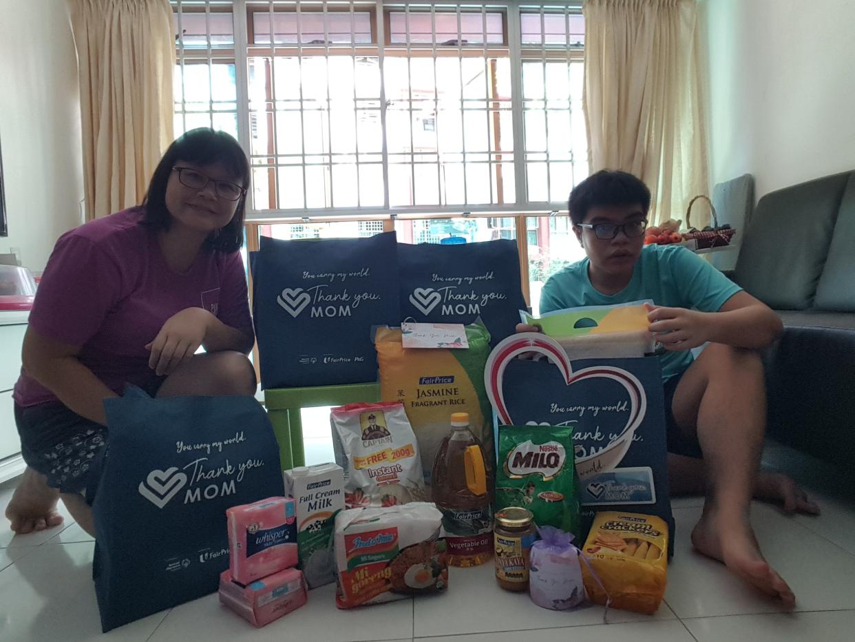 Chan Kam Ling (left), mother of athletics and swimming Special Olympics athlete Jeremy Yeo, with the P&G care packs. (PHOTO: Proctor & Gamble)