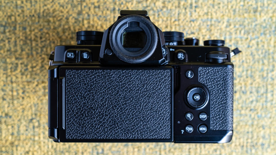 Nikon Z f camera on a vintage-style yellow chair