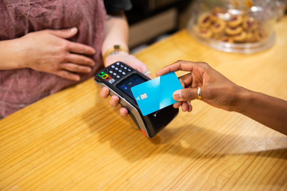 Person paying at a cafe with a credit card