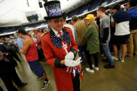 <p>Gregg Donovan, a supporter of Republican presidential candidate Donald Trump, puts on white gloves to match his top hat before the start of a Trump rally in Anaheim, Calif., on May 25, 2016. (Reuters/Jonathan Ernst) </p>