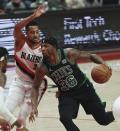 Boston Celtics guard Marcus Smart, right, drives against Portland Trail Blazers guard CJ McCollum, left, during the first half of an NBA basketball game in Portland, Ore., Saturday, Dec. 4, 2021. (AP Photo/Steve Dipaola)