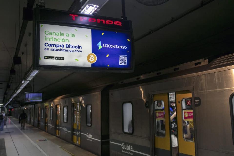 BUENOS AIRES, ARGENTINA - MARCH 17: A virtual currency information for Bitcoins at a metro station on March 17, 2022 in Buenos Aires, Argentina.  Due to a nearly $45 billion debt restructuring deal with the International Monetary Fund (IMF), the Argentine government will discourage and regulate cryptocurrency transactions to prevent money laundering.  Globally, Argentina ranks 14th in terms of cryptocurrency usage.  (Photo: Ricardo Ceppi/Getty Images)