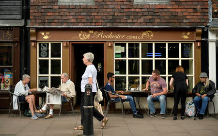 People sit outside a coffee shop in Rochester, Britain, August 8, 2017. Picture taken August 8, 2017. REUTERS/Hannah McKay