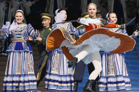 Members of Russian ensemble perform a traditional Cossack's dance with swords during the opening ceremony of the 3rd Krasnoyarsk Asian-Pacific International musical festival in the Siberian city of Krasnoyarsk, in this file photo taken June 29, 2012. REUTERS/Ilya Naymushin/Files