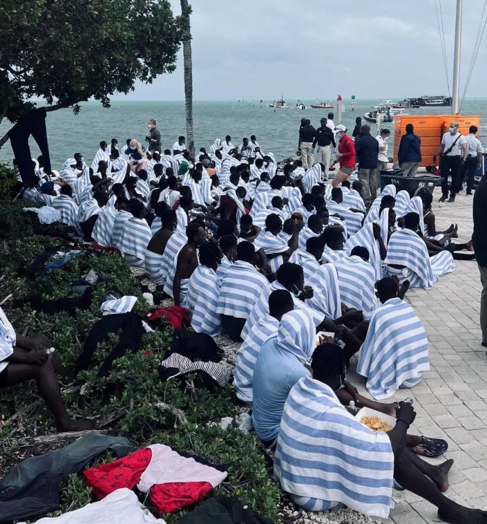 Dozens of Haitian migrants gather on shore at Ocean Reef Club, a gated community in north Key Largo, Sunday, March 6, 2022. The people are part of a large migrant group that arrived on a wooden boat that day.